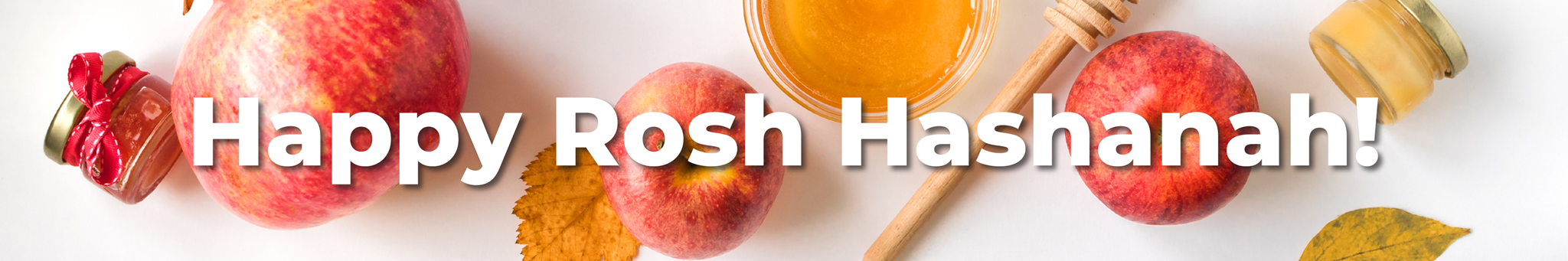 A beautiful Rosh Hashanah dinner table featuring brisket, challah, and apples with honey.
